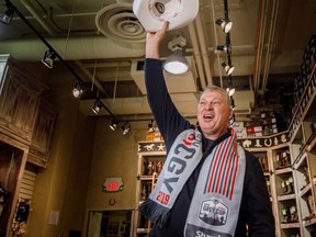 CFL Commissioner Randy Ambrosie yahoos with his official Calgary white hat after Tourism Calgary's Cindy Good swore him in with the official white hat oath at the Lammle's Western Wear shop, on Monday, Nov. 18, 2019.
