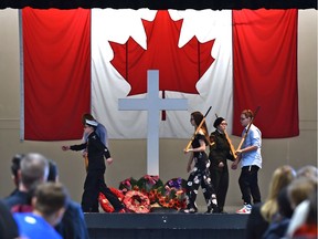 The honour guard marches off the Cenotaph stage after the wreath laying as students and staff remember the nation's heroes at a Remembrance Day ceremony honouring the country's veterans at Vimy Ridge Academy in Edmonton on Friday, Nov. 8, 2019.
