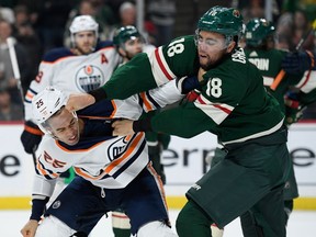 Darnell Nurse of the Edmonton Oilers and Jordan Greenway of the Minnesota Wild throw punches during the second period of the game at Xcel Energy Center on December 12, 2019.