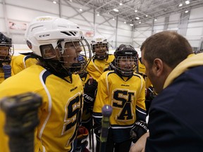 St Albert Adrenaline head coach Chris Kibermanis pumps up his team during a final game versus the Spruce Grove Coyotes in the PeeWee McKinley division during 2017 Quikcard Edmonton Minor Hockey Week at Terwillegar Community Recreation Centre in Edmonton on Sunday, January 22, 2017. Ian Kucerak / Postmedia