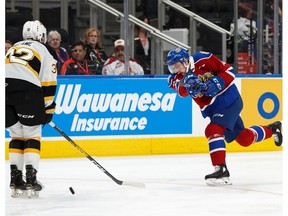 Edmonton Oil Kings' Riley Sawchuk (13) fires a slapshot past Brandon Wheat Kings' Neithan Salame (32) during the second period of a WHL hockey game at Rogers Place in Edmonton, on Sunday, Nov. 17, 2019.
