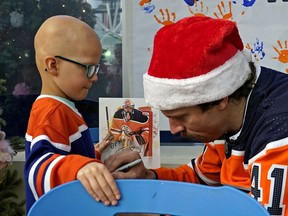 Ben Thomas (5-years-old) gets his jersey autographed by Edmonton Oilers goaile Mike Smith at the Stollery Children's Hospital on Tuesday December 3, 2019. Members of the Edmonton Oilers hockey team made their annual visit to local area hospitals, giving them the chance to bring smiles to people facing trying circumstances during the holiday season.