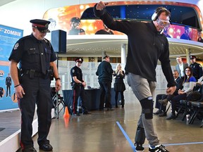 Const. Mike McAuley (L) administers the sobriety test to Oiler Alum Jason Strudwick who is experiences the dangers of impaired driving with Ford's Drunk Driving Suit to reinforce the dangers of impaired driving during the holiday season and to raise awareness of this annual issue in Edmonton, December 5, 2019. Ed Kaiser/Postmedia