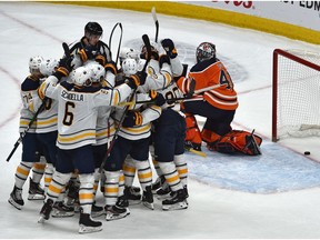 Buffalo Sabres celebrate their overtime goal by Colin Miller (33) on Edmonton Oilers goalie Mike Smith (41) during NHL action at Rogers Place  in Edmonton, December 8, 2019.