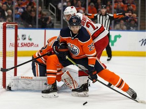 Edmonton Oilers' Darnell Nurse (25) battles Carolina Hurricanes' Nino Niederreiter (21) during the second period of a NHL hockey game at Rogers Place in Edmonton, on Tuesday, Dec. 10, 2019.
