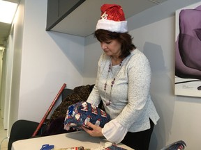 Paola Eastman wraps a present as part of the Home Instead Edmonton's Be a Santa to a Senior Program.