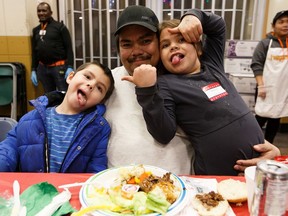 (Left to right) Louis, 6, Louis and Isabella, 7, share a Christmas dinner during Hope Mission's third annual Christmas banquet in Edmonton, on Friday, Dec. 13, 2019. Photo by Ian Kucerak/Postmedia
