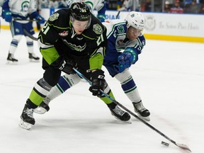 Edmonton Oil Kings' Jake Neighbours (21) battles Swift Current Broncos' Alex Moar (5) during first period WHL hockey action at Rogers Place in Edmonton, on Friday, Dec. 13, 2019.