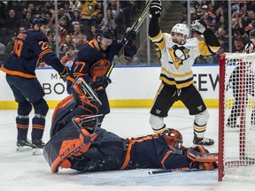 Goaltender Mike Smith (41) of the Edmonton Oilers watches the puck in the back of the net at Zach Aston-Reese (46) of the Pittsburgh Penguins celebrates the Pens first goal at Rogers Place in Edmonton on Friday, Dec. 19, 2019.