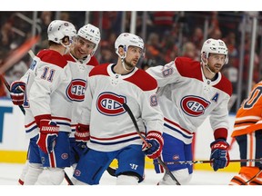 Montreal Canadiens' Phillip Danault (24) celebrates a goal on Edmonton Oilers' goaltender Mikko Koskinen (19) with teammates during second period NHL hockey action at Rogers Place in Edmonton, on Saturday, Dec. 21, 2019.