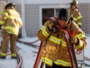 Edmonton firefighters are seen at the scene of a fire on Dec. 22. Firefighters are among the people who work on Christmas Day to ensure residents get help if needed on the holiday.