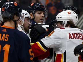 The Edmonton Oilers' Alex Chiasson (39) battles the Calgary Flames' Rasmus Andersson (4) during second period NHL action at Rogers Place, in Edmonton Friday Dec. 27, 2019.