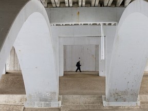 Pedestrians walk under a Fox Drive bridge in Whitemud Creek Park, in Edmonton Tuesday Dec. 10, 2019.