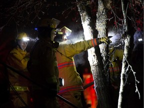 Firefighters return to the scene of a fatal house fire in the hamlet Rochfort Bridge, Friday Dec. 6, 2019. Firefighters had returned to dose hotspots at the home where earlier five people were found dead.