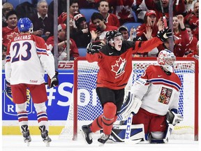 Canada forward Drake Batherson (19) celebrates his goal on Czech Republic goaltender Josef Korenar (30) as Czech Republic defenceman Jakub Galvas (23) looks on during second period semifinal IIHF World Junior Championship hockey action in Buffalo, N.Y. on Thursday, January 4, 2018.