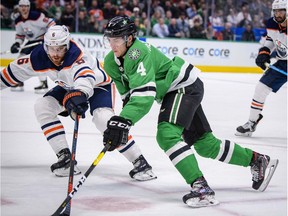 Edmonton Oilers defenceman Adam Larsson defends against Dallas Stars defenceman Miro Heiskanen during the second period at the American Airlines Center.