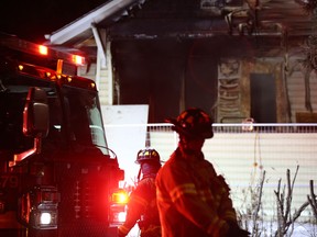 Firefighters respond to a fire in a home slated for demolition on 86 Street near 112 Avenue in Edmonton, Monday, Dec. 9, 2019.