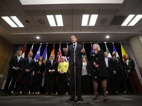 Bill Morneau, Canada's finance minister, center, speaks while Mona Fortier, Canada's associate finance minister and middle class prosperity minister, center right, listens during a news conference with provincial and territorial finance ministers in Ottawa, Ontario, Canada, on Tuesday, Dec. 17, 2019. Photographer: David Kawai/Bloomberg ORG XMIT: 775453454