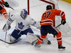 Toronto Maple Leafs goalie Frederik Andersen (left) makes a save on Edmonton Oilers captain Connor McDavid during first period NHL hockey game action in Edmonton on Saturday December 14, 2019. (PHOTO BY LARRY WONG/POSTMEDIA)