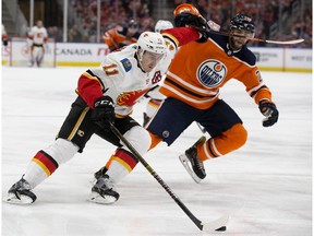 The Edmonton Oilers' Darnell Nurse (25) chases the Calgary Flames' Mikael Backlund (11) during second period NHL action at Rogers Place, in Edmonton Saturday Jan. 19, 2019.