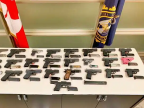 A pink handgun was among 25 firearms allegedly found stashed in the gas tank of a vehicle that attempted to cross the border into Canada at Fort Erie recently. (Toronto Police handout)