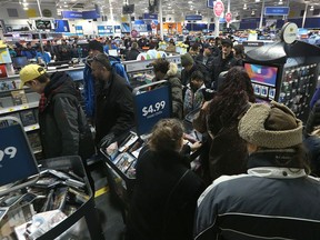 Customers queue at the Best Buy in the Crossroads Station Shopping Centre on Regent Avenue in Winnipeg on Tues., Dec. 26, 2017. Kevin King/Winnipeg Sun/Postmedia Network