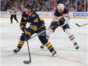 BUFFALO, NY - JANUARY 02: Victor Olofsson #68 of the Buffalo Sabres skates with the puck and draws a penalty on Zack Kassian #44 of the Edmonton Oilers during the second period at KeyBank Center on January 2, 2020 in Buffalo, New York.