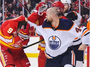 Zack Kassian #44 of the Edmonton Oilers fights Matthew Tkachuk #19 of the Calgary Flames during an NHL game at Scotiabank Saddledome on January 11, 2020 in Calgary.