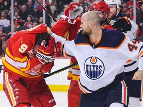 Zack Kassian (44) of the Edmonton Oilers pummels Matthew Tkachuk (19) of the Calgary Flames during an NHL game at Scotiabank Saddledome on Jan. 11, 2020 in Calgary.