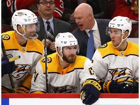 Head coach John Hynes of the Nashville Predators gives instructions to players on the bench during a game against the Chicago Blackhawks at the United Center on January 09, 2020 in Chicago, Illinois. The Predators defeated the Blackhawks 5-2.