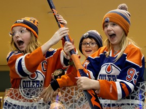 Kianna Hopson, 11, left, Benjamin Kipling, 9, and Brooklynn Nicole, 10, react after receiving a stick from Edmonton Oilers goaltender Mike Smith following a practice inside West Edmonton Mall on Monday Jan. 27, 2020.