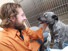 Josh Kuchenbrand visits his dog Busy at the North Battleford Animal Hospital after Busy was shot while on his property north of Biggar. (Mandy Ferner/ Facebook)