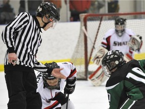 A referee drops the puck for atom AA teams SWAT Spitfires and the Spruce Grove Saints playing in the Quikcard Edmonton Minor Hockey Week at the Terwillegar Community Recreation Centre in Edmonton.