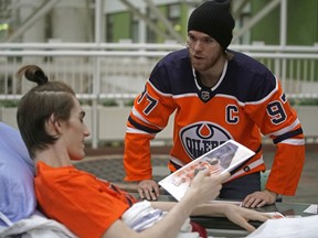 Edmonton Oilers captain Connor McDavid chats with patient Cole Golson at the Stollery Children's Hospital in Edmonton on Dec. 21, 2018, where he and some team members paid a visit and signed autographs. Two Corus radio stations — 630 CHED and CISN FM, iNews 880 and The Chuck — are plugged in at the Stollery Children’s Hospital this month to raise $1.5 million.
