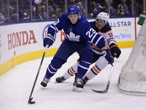 Maple Leafs defenceman Travis Dermott (23) tries to get around Edmonton Oilers forward Josh Archibald (15) during the second period at Scotiabank Arena. Mandatory Credit: John E. Sokolowski-USA TODAY Sports