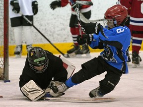 Flaming Jaguars SW313 goalie Lincoln Pelech (7-years-old) makes a save on Jake Robinson (7-years-old) during a team practice at Terwillegar Community Recreation Centre in Edmonton on January 9, 2020. The 57th annual Quikcard Edmonton Minor Hockey Week, one of the biggest hockey tournaments of the year, was held at over 30 arenas in Edmonton from January 10-19, 2020.