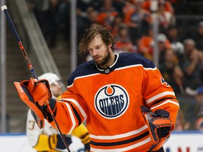 Edmonton Oilers goaltender Mike Smith (41) loses his helmet to a slapshot from Nashville Predators' Craig Smith (15) at Rogers Place in Edmonton on Tuesday, Jan. 14, 2020.