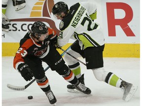 Edmonton Oil Kings forward Jake Neighbours (right) is checked by Medicine Hat Tigers Bryan Lockner at Rogers Place on Sunday, Jan. 19, 2020.