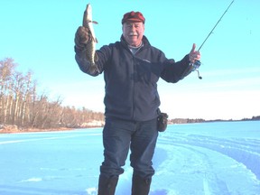 Neil with a bonus Halfmoon pike. Neil Waugh/Edmonton Sun