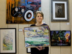 Artist Karen Bishop poses for a photo at the Creative Collective Artists Society temporary gallery at Bonnie Doon Mall, in Edmonton Friday Jan. 17, 2020. Bishop is a member of a group called Alberta Arts Matter and is protesting the proposed closure of the Alberta Branded store at the Legislative Assembly Visitor Centre. Photo by David Bloom