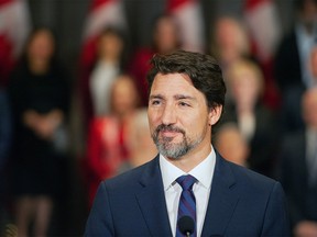 Prime Minister Justin Trudeau stands in front of his cabinet as he speaks to media during the final day of the Liberal cabinet retreat at the Fairmont Hotel in Winnipeg, Tuesday, Jan. 21, 2020. THE CANADIAN PRESS/Mike Sudoma ORG XMIT: WPGX110