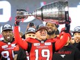 Calgary Stampeders quarterback Bo Levi Mitchell raises the Grey Cup after defeating the Ottawa Redblacks at Commonwealth Stadium in Edmonton on Sunday Nov. 25, 2018.