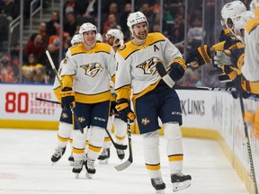 Nashville Predators forward Filip Forsberg (9) celebrates a goal with teammates on Edmonton Oilers' goaltender Mike Smith (41) during first period NHL hockey action at Rogers Place in Edmonton, on Tuesday, Jan. 14, 2020.