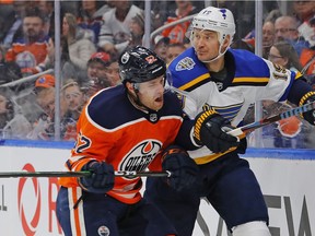 Oilers forward Patrick Russell (52) checks St. Louis Blues defensemen Jay Bouwmeester (19) during the first period at Rogers Place, Nov 6, 2019.