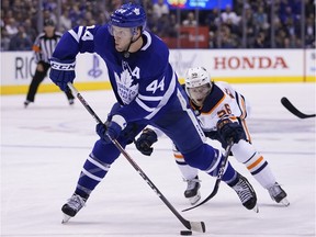 Toronto Maple Leafs defenceman Morgan Rielly (44) goes to shoot the puck as Edmonton Oilers forward Kailer Yamamoto (56) defends at Scotiabank Arena. Edmonton defeated Toronto.