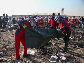 Red Crescent workers check plastic bags at the site where the Ukraine International Airlines plane crashed after take-off from Iran's Imam Khomeini airport, on the outskirts of Tehran, Iran January 8, 2020. Nazanin Tabatabaee/WANA (West Asia News Agency)