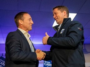 Peter MacKay shakes hands with Leader of Canada's Conservatives Andrew Scheer in Little Harbour, Nova Scotia, Canada, on Oct. 17, 2019. (REUTERS/Carlos Osorio)