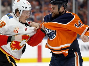 The Edmonton Oilers' Zack Kassian (44) fights the Calgary Flames' Matthew Tkachuk (19) during first period NHL action at Rogers Place, in Edmonton Wednesday Jan. 29, 2020.
