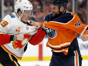 The Edmonton Oilers' Zack Kassian (44) fights the Calgary Flames' Matthew Tkachuk (19) during first period NHL action at Rogers Place, in Edmonton Wednesday Jan. 29, 2020.