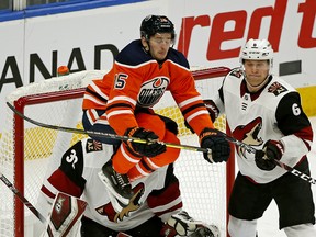 Edmonton Oilers Josh Archibald leaps in front of Arizona Coyotes goalie Antii Raanta and defenceman Jakob Chychrun during second period NHL hockey game action in Edmonton on Saturday  January 18, 2020.